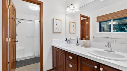 a bathroom with two sinks and a shower at Eagles Bluff by AvantStay in Greenbank