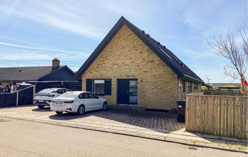 a white car parked in front of a brick house at Awesome Home In Thyborøn With Wifi in Thyborøn