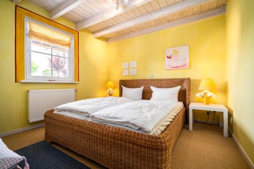 a bedroom with a large bed and a window at Ferienhaus Kathi - Ihre Auszeit direkt am See in Jabel in Jabel