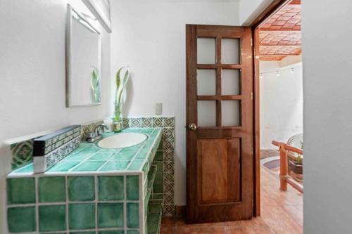 a bathroom with a sink and a mirror at Casa Carmela in Sayulita