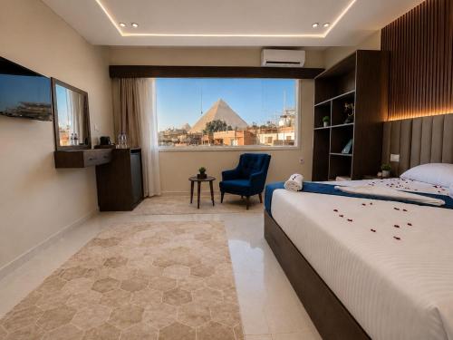 a bedroom with a bed and a view of the pyramids at Leeda Pyramids View in Cairo
