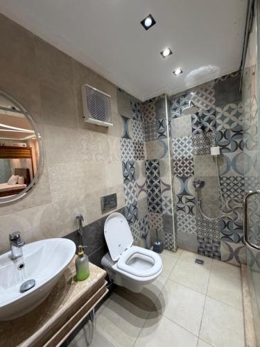 a bathroom with a toilet and a sink at برج زيزينيا in Port Said