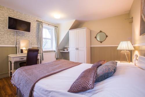 a bedroom with a bed with two animal pillows on it at The Manor at Bickley in Bromley