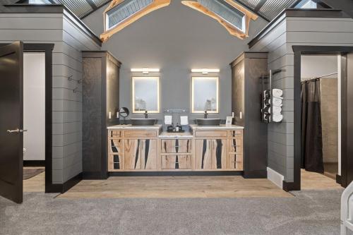 a bathroom with two sinks and two mirrors at The Bald Doe in Sturgis