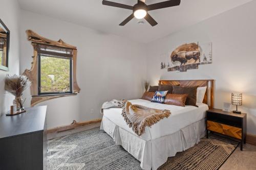 a bedroom with a bed and a ceiling fan at The Bald Doe in Sturgis