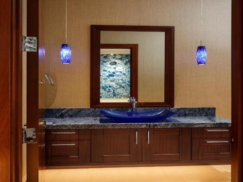 a bathroom with a blue sink and a mirror at Villa with pool extraordinary view in Lahaina in Lahaina