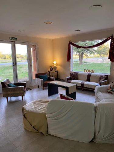 a large living room with two beds and a couch at Hotel Mirage Spa in Carhué