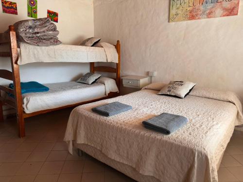 a room with two beds and a bunk bed at Functional Department in Colorado River