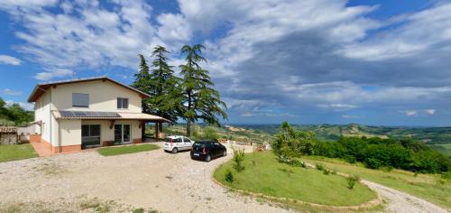 a house with a car parked in the driveway at B&B Al Tardino in Sogliano al Rubicone