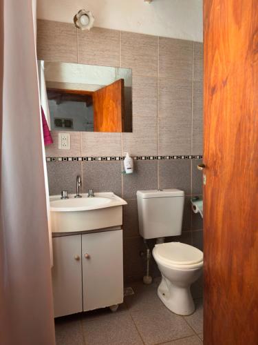 a bathroom with a toilet and a sink and a mirror at Functional Department in Colorado River