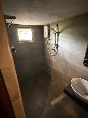 a bathroom with a shower and a sink at D-Chu Mountain Haven Villas in Vang Vieng