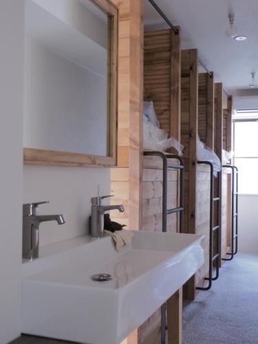 a bathroom with a white sink and a mirror at Asagaya Iriguchi in Tokyo