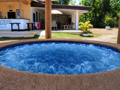 a large pool of blue water in front of a house at Seaview Moonrise Café in Alcoy