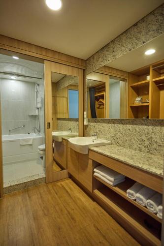a bathroom with a sink and a tub and a toilet at Acube Hotel Dongdaemun in Seoul