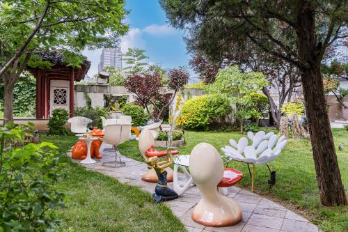 a group of chairs and tables in a garden at Beijing Landmark Hotel in Beijing