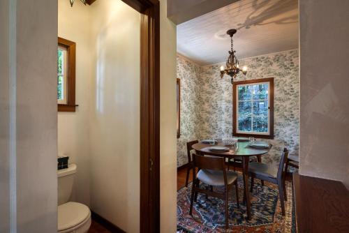 a dining room with a table and a toilet at Wanderwood in Guerneville