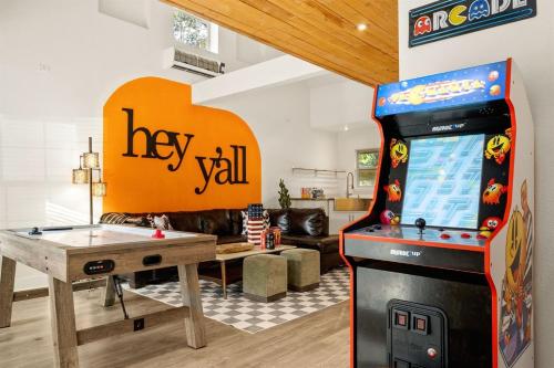 a living room with a video game console and a pool table at 6BR Pool & Game Arcade Family Dog Friendly in San Antonio