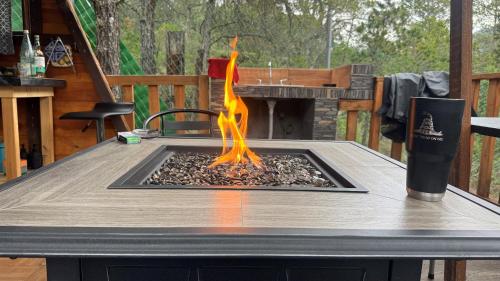 a fire pit on a table on a deck at Glamping MORET Tiny House M1 in Los Lirios