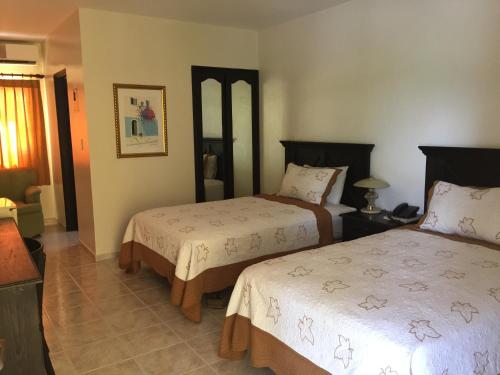 Ένα ή περισσότερα κρεβάτια σε δωμάτιο στο Hotel Las Caobas