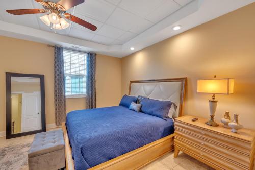 a bedroom with a blue bed and a ceiling fan at Elegant Jewel Sports Event Hosting in Lithonia