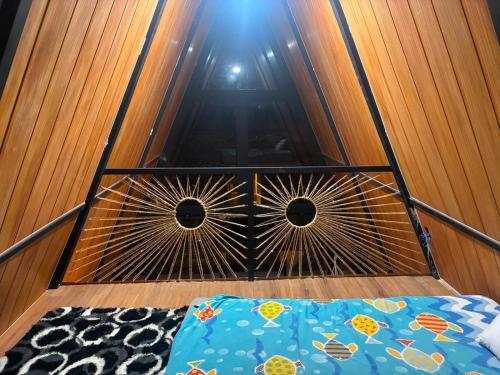 a bedroom with a bed and a wooden wall at Chalés parada ideal in Guapimirim