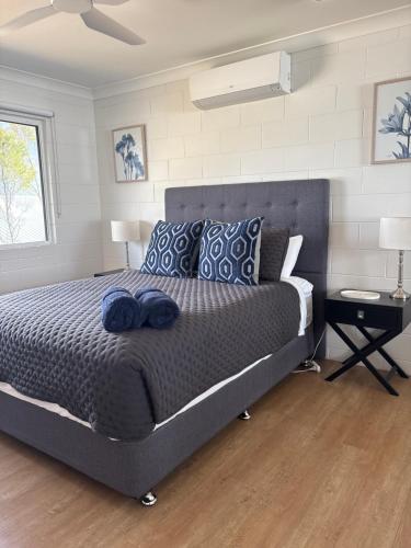 a bedroom with a large bed with blue pillows at Apartment on Henry in North Ward