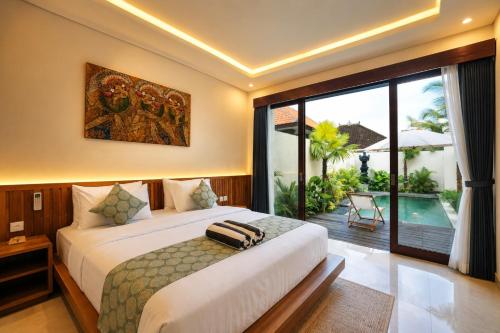 a bedroom with a bed and a balcony with a pool at Denaya Villa in Ubud