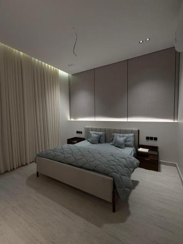 a bedroom with a large bed and some curtains at رجبانية in Jeddah