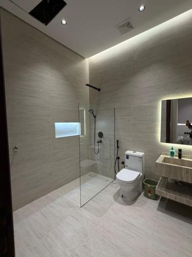 a bathroom with a shower and a toilet and a sink at رجبانية in Jeddah