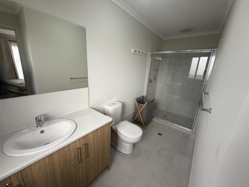a bathroom with a sink and a toilet and a shower at Parsee Escape in Edithburgh