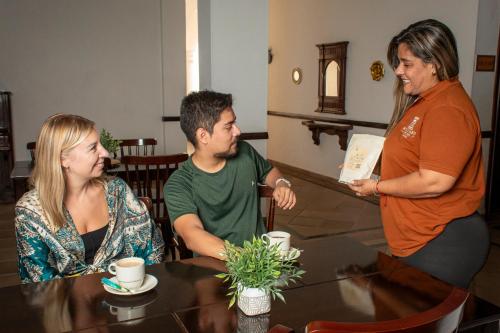a group of people sitting around a table at Hotel Boulevard del Río in Cali