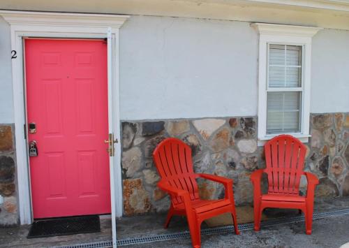 two red chairs sitting in front of a red door at Red Bank Cozy Nest in Chattanooga