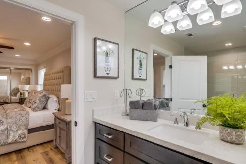 a bathroom with a sink and a large mirror at Gorgeous Upgraded 5 Bedroom & 4 Bath Home with Jacuzzi in Orange