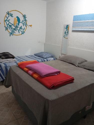 two beds with towels on top of them in a room at Pousada Hostel Brasil Gru in Guarulhos