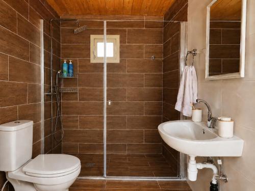 a bathroom with a toilet and a sink at The Heart Cabin בקתת הלב in Kidmat Tsvi