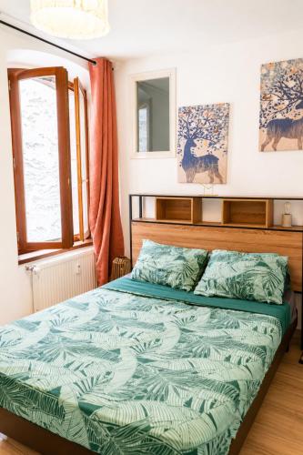 a bedroom with a bed and a window at T2 centre Ville Proche des pistes in Briançon