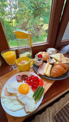 a breakfast table with eggs and vegetables and bread at Eko Dworek tylko 1500m do wejścia Energylandii in Zator
