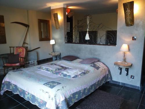 a bedroom with a bed and two tables and a chair at chambres d hotes ,hotel ,Secret d'une Nuit a vicq prės de valenciennes,onnaing,saint saulve avec piscine , jaccuzi in Valenciennes