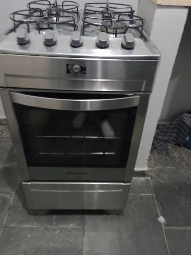 a stainless steel stove in a kitchen at Rua da Expo Itaguaí in Itaguaí