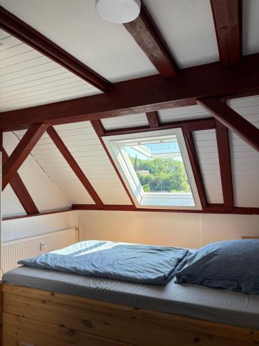 a bed in a room with a window at Über der Brücke in Melsungen