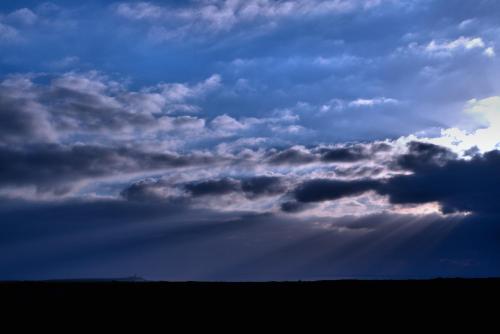 a cloudy sky with the sun poking through the clouds at Tonel Apartamentos Turisticos in Sagres