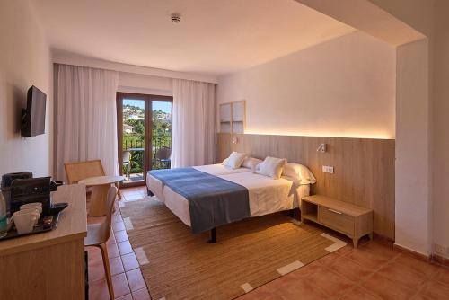 a hotel room with a bed and a balcony at Hotel Navia Santa Ponsa - Adults Only in Santa Ponsa