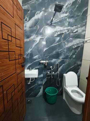a bathroom with a toilet and a sink at S J RESiDENCY in Trivandrum