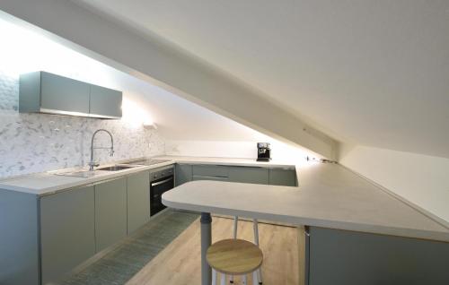 a white kitchen with a sink and a counter at Awesome Apartment In Millesimo With Wifi in Millesimo