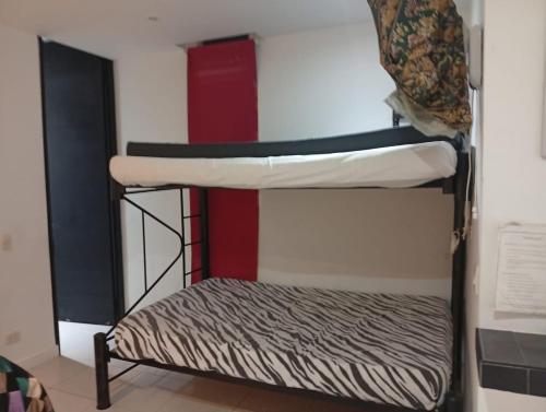a couple of bunk beds in a room at Comfortable suite-style studio apartment to rest in Flandes