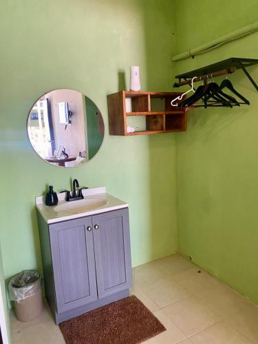 a bathroom with a sink and a mirror at Pelican Inn at Las Dunas Chelem in Chelem