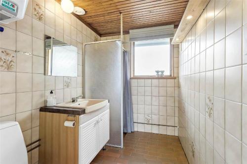 a bathroom with a sink and a toilet and a window at FY273-Millinge-Buursminde-2 in Millinge