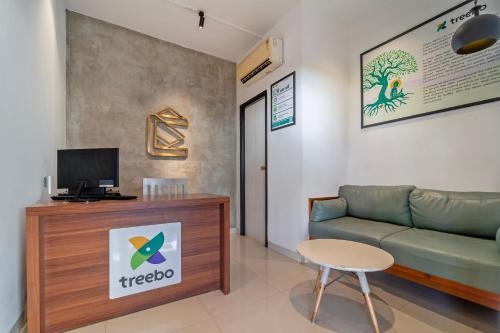 a living room with a couch and a table at Treebo Premium Corner Stay in Coimbatore