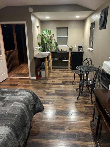 a room with a bed and a table and a kitchen at Grand Canyon tiny homes in Williams
