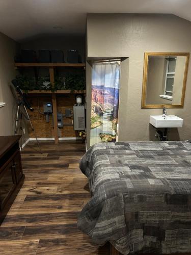 a bedroom with a bed and a sink and a window at Grand Canyon tiny homes in Williams
